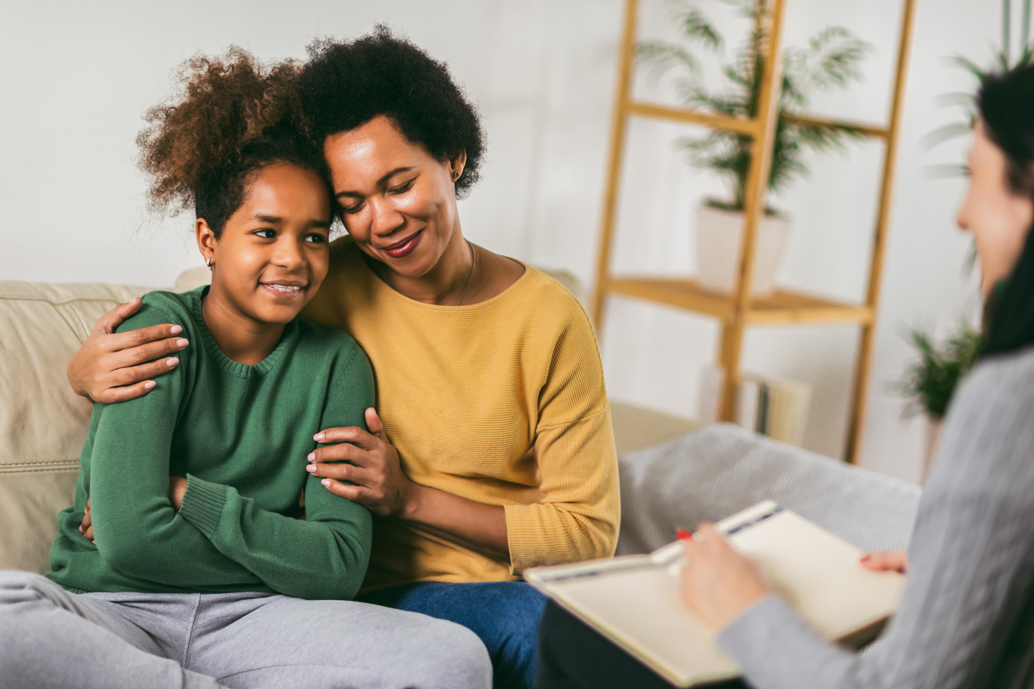 A mother and teenage daughter meeting with a therapist.